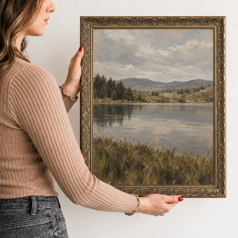 Along the Lake Shore Wall Art in a Gold Ornate Frame, held to show its size