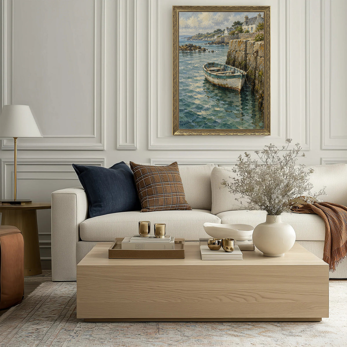 Beneath the Seawall Wall Art in a Gold Ornate Frame above a cream sofa in a living room