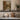 Bridge over the Mill Stream Wall Art in a Black Floating Frame on a kitchen shelf