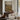 Meadow Beneath the Ridge Wall Art in a Black Floating Frame above a walnut console in a sitting room