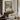 Snow on the Village Lane Wall Art in a Gold Ornate Frame above a walnut console in a sitting room