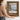 The Chalet Window Wall Art in a Gold Ornate Frame, held to show its size