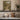 The Flowering Steps Wall Art in a Gold Ornate Frame on a kitchen shelf