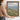The Headland Wall Art in a Gold Ornate Frame, held to show its size