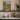 The Limestone Cottage Wall Art in a White Floating Frame on a kitchen shelf