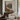 The Lodge Across the Loch Wall Art in a Black Floating Frame above a walnut console in a sitting room