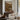 The Millrace Wall Art in a Black Floating Frame above a walnut console in a sitting room