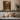 The Old Mill Wall Art in a White Floating Frame on a kitchen shelf