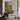 The Old Orchard Wall Art in a Black Floating Frame above a walnut console in a sitting room