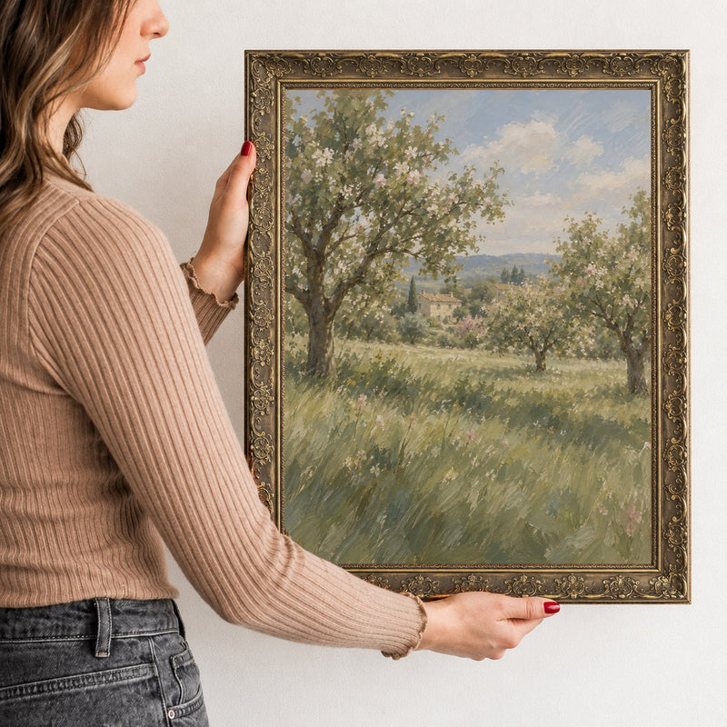 The Old Orchard Wall Art in a Gold Ornate Frame, held to show its size