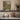 The Old Orchard Wall Art in a White Floating Frame on a kitchen shelf