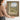 The Open Window Wall Art in a Gold Ornate Frame, held to show its size