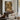 The Quiet Courtyard Wall Art in a Black Floating Frame above a walnut console in a sitting room