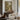 The Rose Walk Wall Art in a Gold Ornate Frame above a walnut console in a sitting room