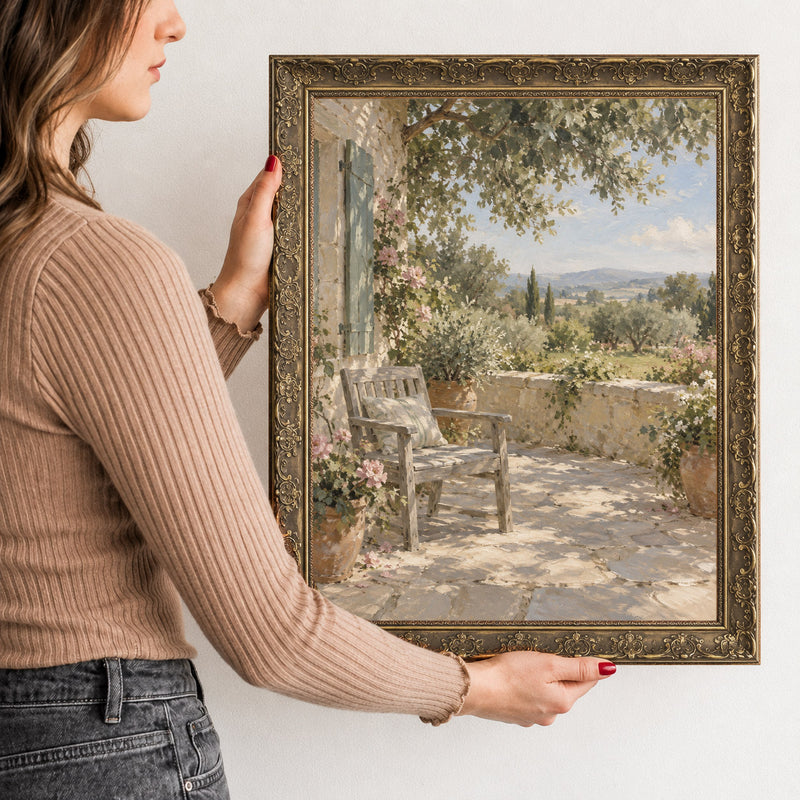 The Shaded Terrace Wall Art in a Gold Ornate Frame, held to show its size
