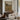 The Shepherd's Shelter Wall Art in a Gold Ornate Frame above a walnut console in a sitting room