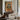 The Shuttered Balcony Wall Art in a Black Floating Frame above a walnut console in a sitting room