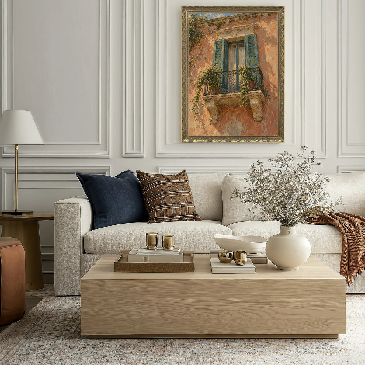 The Shuttered Balcony Wall Art in a Gold Ornate Frame above a cream sofa in a living room