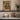 The Shuttered Balcony Wall Art in a White Floating Frame on a kitchen shelf