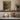The Stone Basin Wall Art in a White Floating Frame on a kitchen shelf