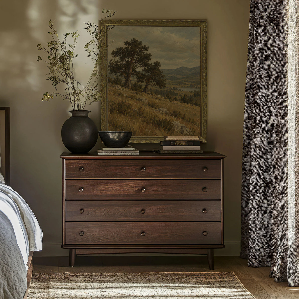 The Twin Pines Wall Art in a Gold Ornate Frame above a walnut dresser in a bedroom