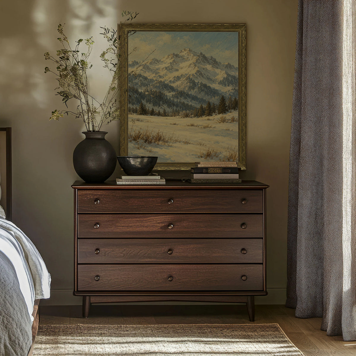 The Winter Peak Wall Art in a Gold Ornate Frame above a walnut dresser in a bedroom