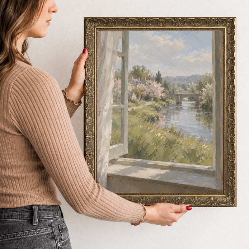 Window Above the River Wall Art in a Gold Ornate Frame, held to show its size